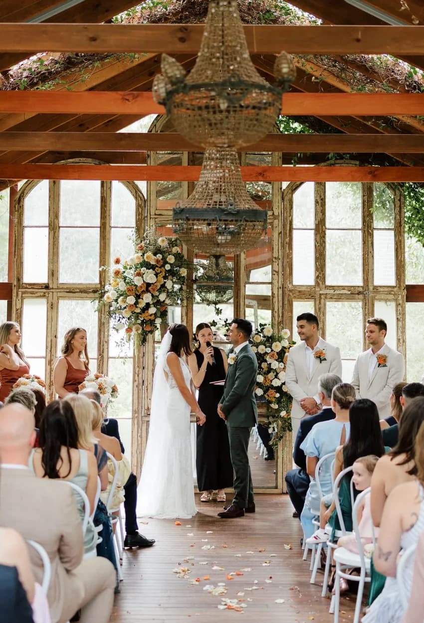 The whole bush chapel during the ceremony, chandeliers and greenery overhead, at Jordan and Michael's own wedding at The Woods Farm, Jervis Bay