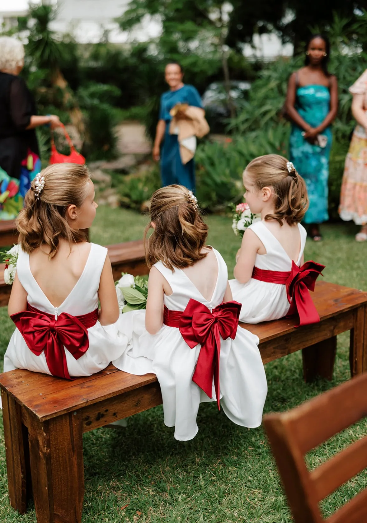 Flower girls with red ribbons for wedding