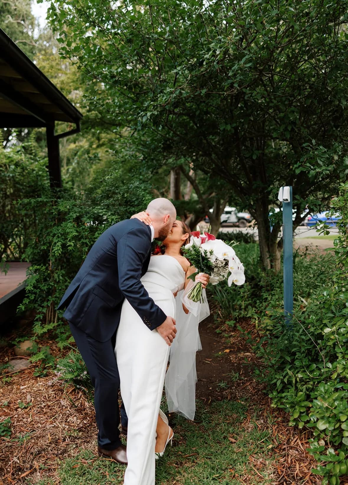 Bride and groom kissing wedding day