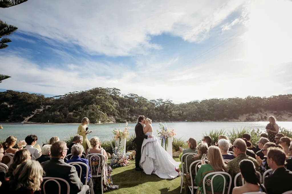 Bride and groom kissing during ceremony at The Cove Jervis Bay