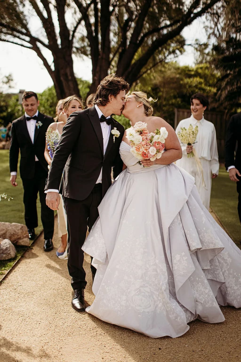 Bride and groom kissing while walking at The Cove Jervis Bay
