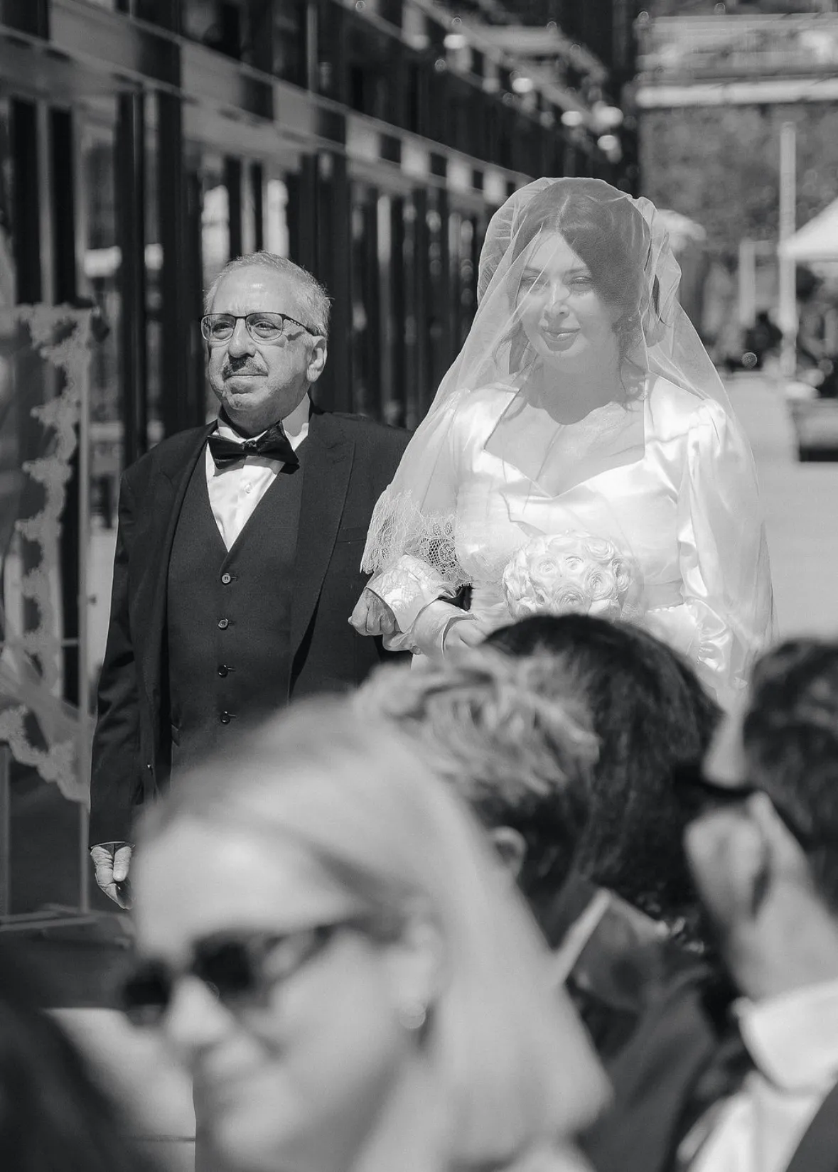 Bride and father walking down the aisle, black and white wedding photo
